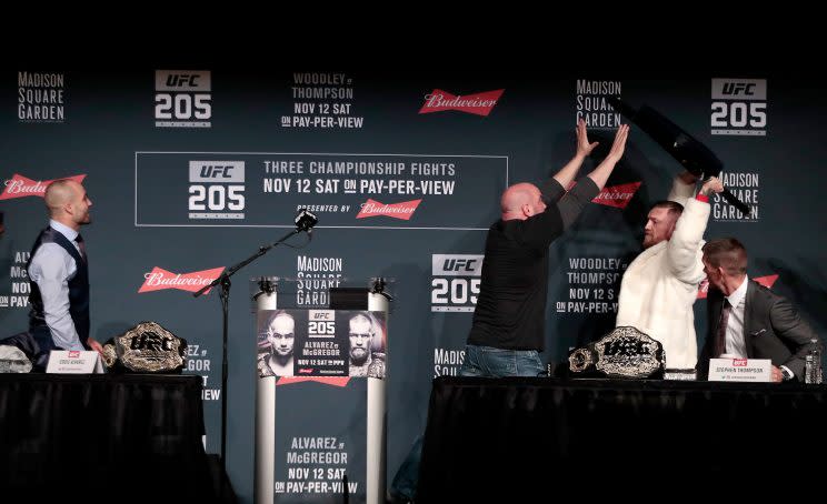 Conor McGregor tries to throw a chair at Eddie Alvarez during the UFC 205 news conference. (AP)
