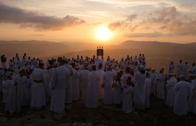 Samaritan worshippers hold a Torah scroll during a traditional pilgrimage marking the holiday of Sukkot, or Feast of Tabernacles, on top of Mount Gerizim, near the northern city of Nablus in the Israeli-occupied West Bank, on Oct. 20. (Photo: EMMANUEL DUNAND/AFP via Getty Images)