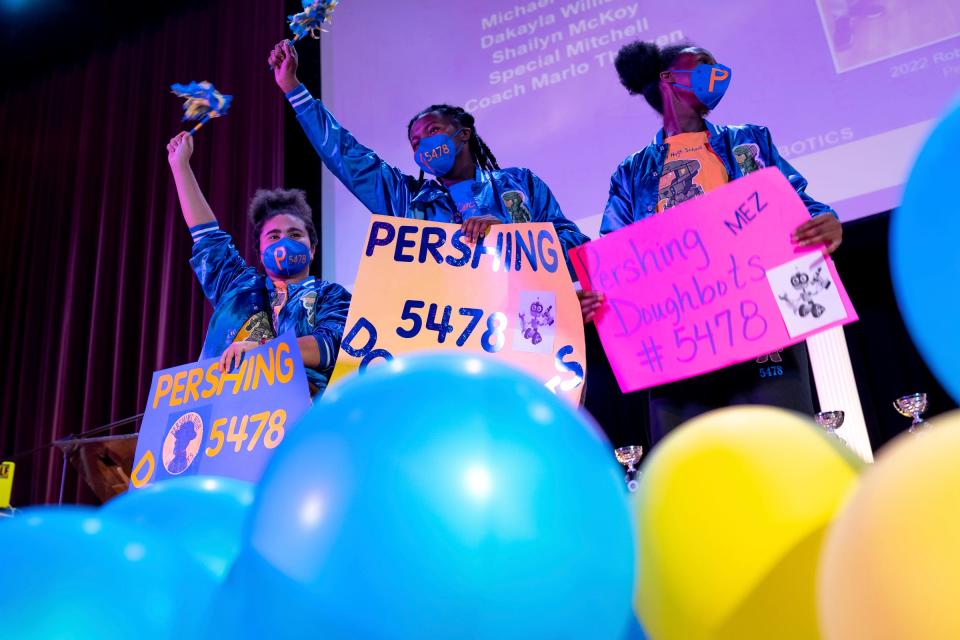 Pershing High School students Dakayla Williams, left, Shailyn McKoy and Special Mitchell take the stage to be recognized during the third annual Detroit Public School Community District STEM Awards at Martin Luther King High School in Detroit on Thursday, June 9, 2022. Students from K-12 that have excelled in a variety of STEM activities this school year were honored, along with educators that have helped the students succeed.