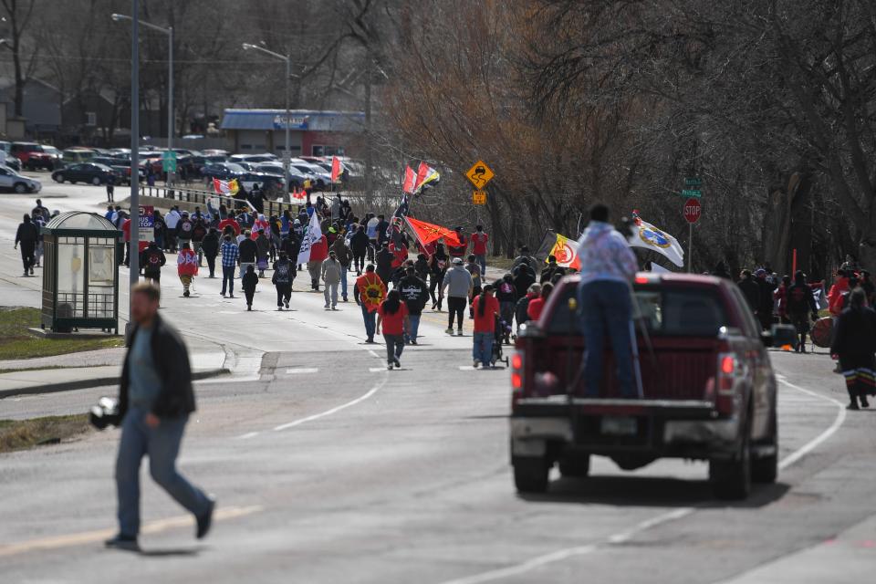 Demonstrators walk for the March for Justice on Friday, April 5, 2024, along North Drive in Sioux Falls.