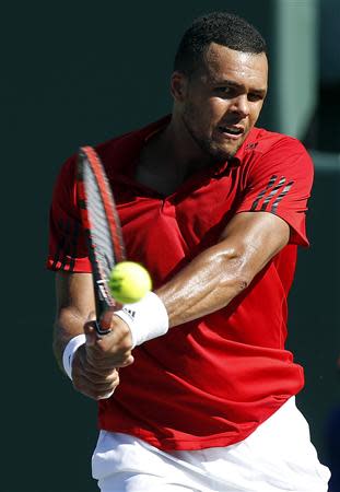 Mar 25, 2014; Miami, FL, USA; Jo-Wilfried Tsonga hits a backhand against Andy Murray (not pictured) on day nine of the Sony Open at Crandon Tennis Center. Geoff Burke-USA TODAY Sports