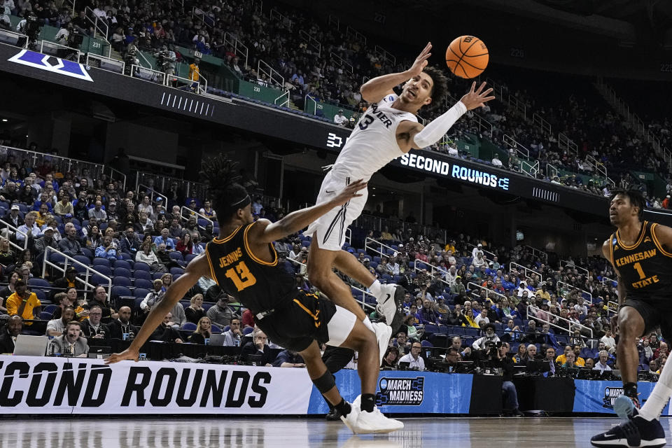 Xavier guard Colby Jones passes away from Kennesaw State guard Kasen Jennings during the first half of a first-round college basketball game in the NCAA Tournament on Friday, March 17, 2023, in Greensboro, N.C. (AP Photo/Chris Carlson)