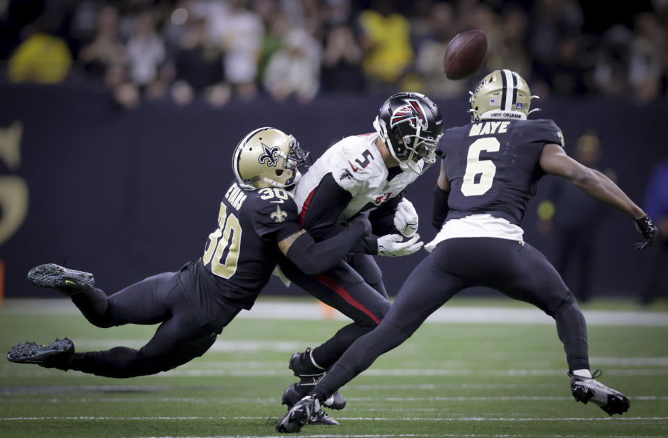 New Orleans Saints safety Justin Evans (30) hits Atlanta Falcons wide receiver Drake London (5) forcing a fumble during an NFL football game in New Orleans on Sunday, Dec 18, 2022. (Brett Duke/The Times-Picayune/The New Orleans Advocate via AP)