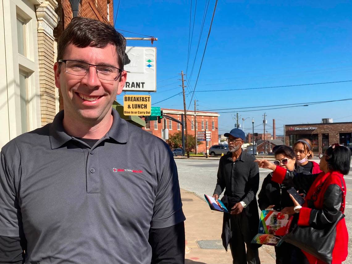 Josh Rogers, president and CEO of NewTown Macon, talks about the 2022 Tour of Progress while tour participants take a look at the Billingslea Commons development in the 800 block of Forsyth St. in downtown Macon.
