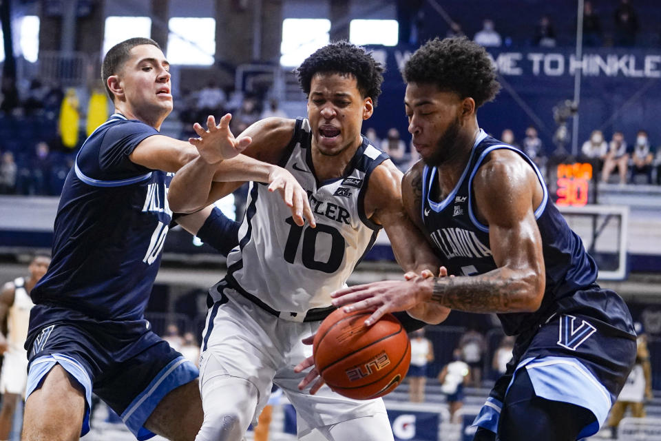 Villanova guard Justin Moore (5) makes a steal from Butler forward Bryce Nze (10) in the second half of an NCAA college basketball game in Indianapolis, Sunday, Feb. 28, 2021. (AP Photo/Michael Conroy)