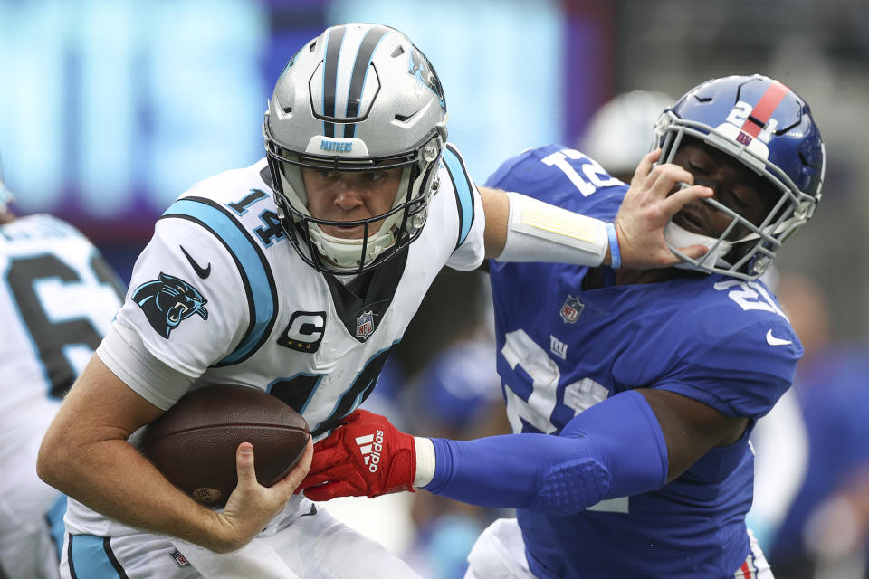 EAST RUTHERFORD, NEW JERSEY - OCTOBER 24: Sam Darnold #14 of the Carolina Panthers is sacked by Jabrill Peppers #21 of the New York Giants during the first half in the game at MetLife Stadium on October 24, 2021 in East Rutherford, New Jersey. (Photo by Al Bello/Getty Images)