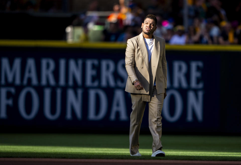 Former Seattle Mariners pitcher Felix Hernandez walks on the field as he arrives during his induction ceremony into the Mariners' Hall of Fame before a baseball game between the Mariners and the Baltimore Orioles, Saturday, Aug. 12, 2023, in Seattle. (AP Photo/Lindsey Wasson)