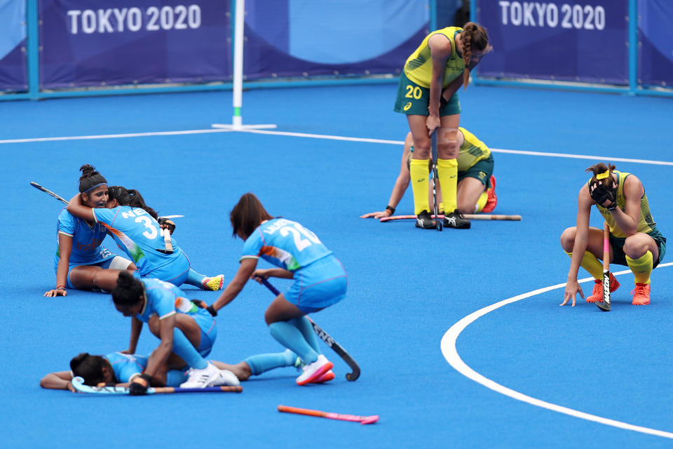 TOKYO, JAPAN - AUGUST 02: Navneet Kaur, Neha Neha and Lalremsiami of Team India celebrate their 1-0 win with teammates while Karri Somerville reacts after the Women's Quarterfinal match between Australia and India on day ten of the Tokyo 2020 Olympic Games at Oi Hockey Stadium on August 02, 2021 in Tokyo, Japan. (Photo by Buda Mendes/Getty Images)