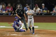 New York Yankees' Giancarlo Stanton, right, watches the flight of his solo home run as Texas Rangers catcher Jonah Heim, left, and umpire Andy Fletcher, center, look on in the eighth inning of a baseball game in Arlington, Texas, Monday, Oct. 3, 2022. (AP Photo/Tony Gutierrez)