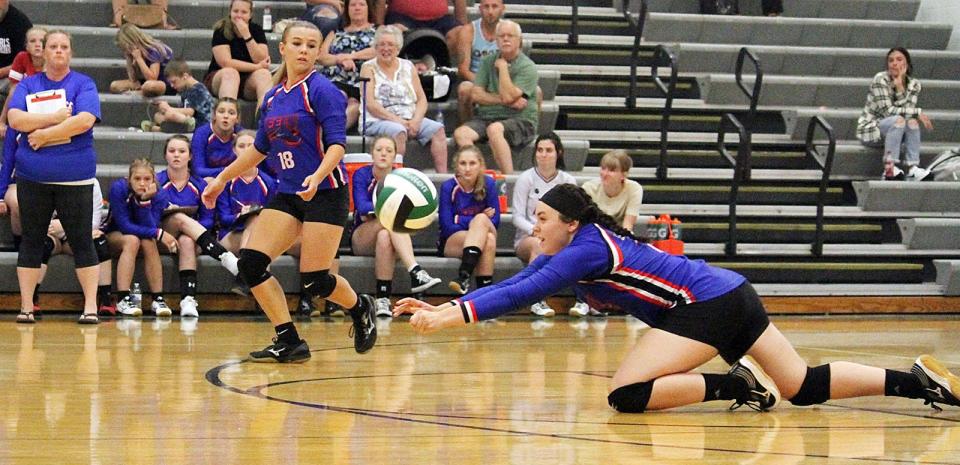 Eminence junior Grace Kemp gets a dig while coach Laci Hamblen and teammates look on during the match at Monrovia on Tuesday, Aug. 24, 2021. 