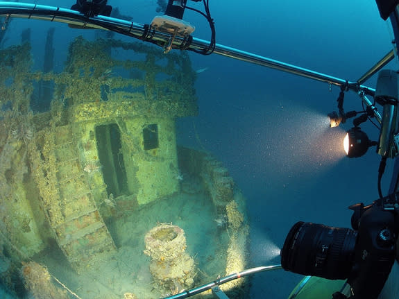 Lionfish gather near the doorway of this sunken ship, the Bill Boyd, in this image taken by researchers inside the submersible Antipodes.