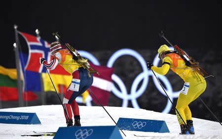 Biathlon - Pyeongchang 2018 Winter Olympics - Men's 4x7.5 km Relay Final - Alpensia Biathlon Centre - Pyeongchang, South Korea - February 23, 2018 - Johannes Thingnes Boe of Norway and Sebastian Samuelsson of Sweden compete. REUTERS/Toby Melville