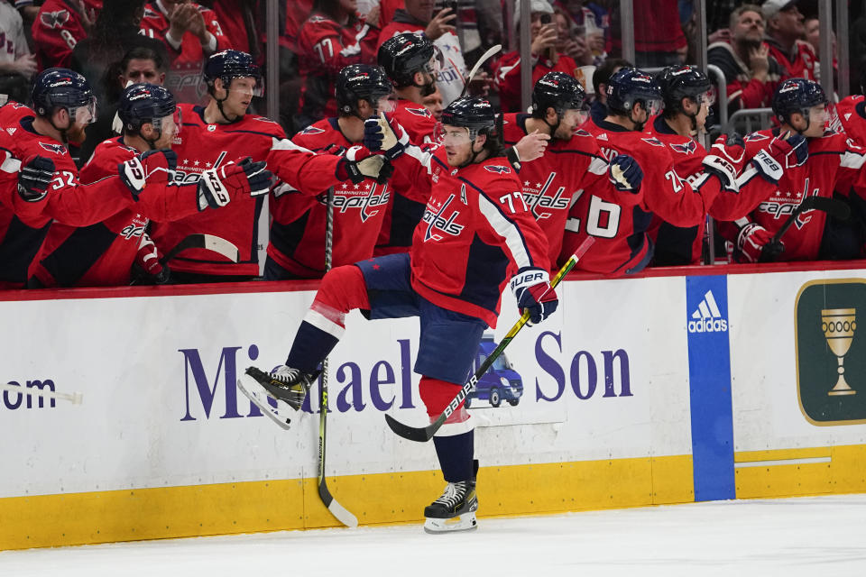 Washington Capitals right wing T.J. Oshie (77) skates by his bench after scoring a goal against the New York Rangers during the second period of an NHL hockey game, Saturday, Feb. 25, 2023, in Washington. (AP Photo/Julio Cortez)