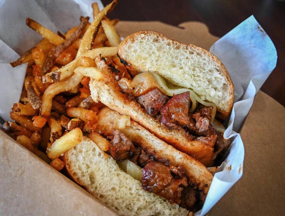 A barbecue tri-tip and provolone sandwich with french fries made from fresh potatoes is boxed up at the Grazing Table Deli in northeast Fresno on Wednesday, May 10, 2023.