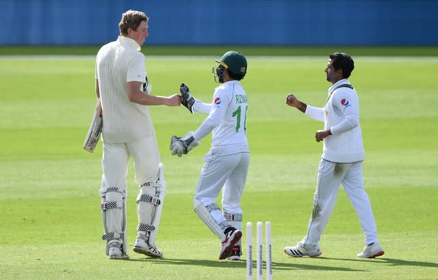 Crawley (left) bumps fists with Pakistan’s Mohammed Rizwan 