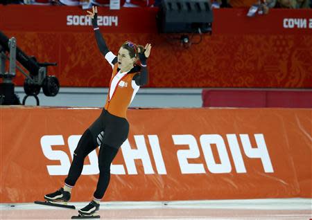 Irene Wust of the Netherlands reacts after her women's 3000 meters speed skating race during the 2014 Sochi Winter Olympics, February 9, 2014. REUTERS/Marko Djurica