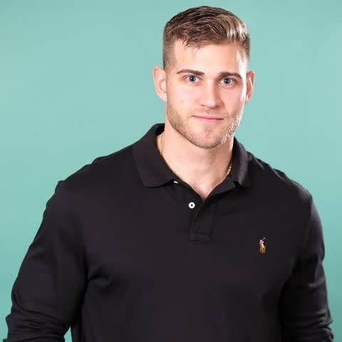 Luke P. poses against a Tiffany colored background