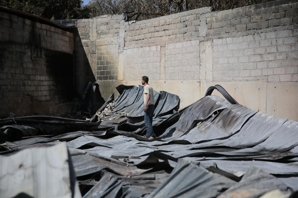 A worker inspects the rubble of a plastic materials factory destroyed by Saudi-led airstrikes, in Sanaa, Yemen, Tuesday, Nov. 23, 2021. (AP Photo/Hani Mohammed)