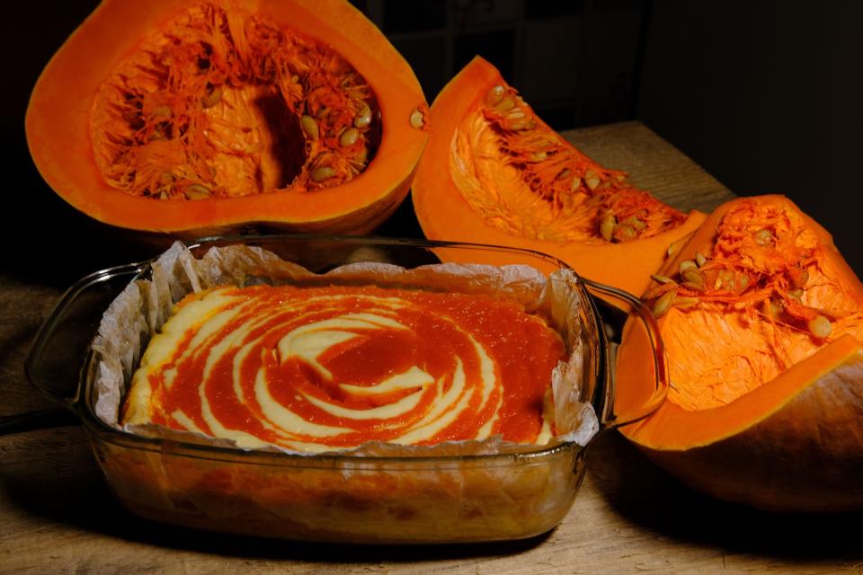 Homemade pumpkin pie cheesecake with piece of pumpkin sliced on parts