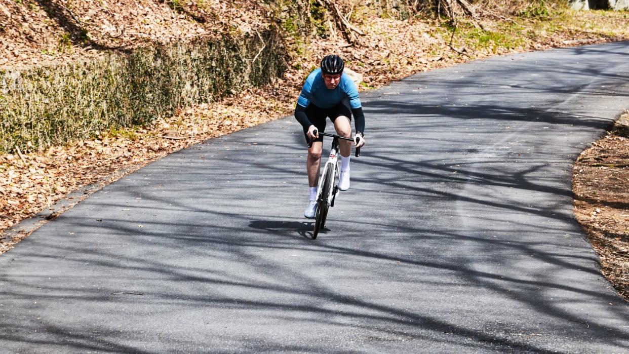 a person riding a bike down a road fast