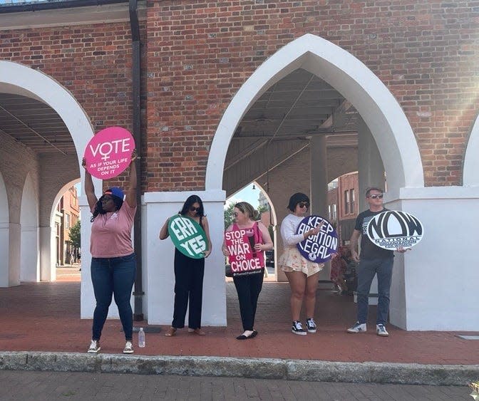 Activists gather at the Market House in downtown Fayetteville on Friday evening to protest the U.S. Supreme Court ruling that overturned Roe v. Wade, which protected abortion rights nationwide for nearly five decades.