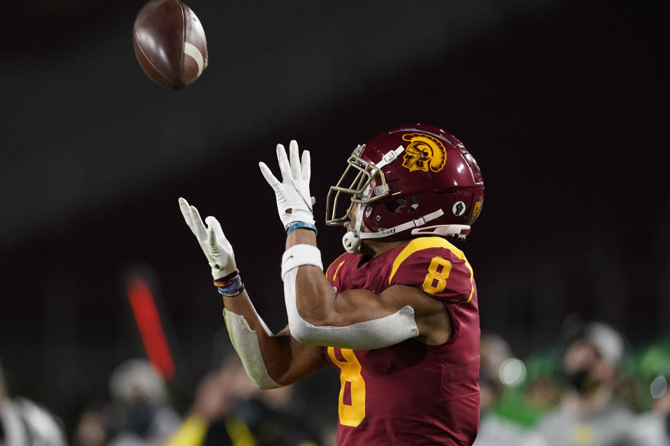 Southern California wide receiver Amon-Ra St. Brown (8) catches a pass before running to the end zone for a touchdown during the first quarter of an NCAA college football game for the Pac-12 Conference championship against Oregon Friday, Dec 18, 2020, in Los Angeles. (AP Photo/Ashley Landis)