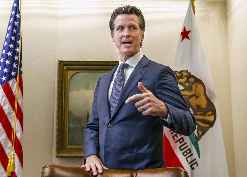 FILE - In this July 12, 2019, file photo, California Gov. Gavin Newsom talks with reporters at his office in Sacramento, Calif. On Friday, April 23, 2021, Gov. Newsom announced he would halt all new fracking permits in the state by January 2024. He also ordered state regulators to plan for halting all oil extraction in the state by 2045. (AP Photo/Rich Pedroncelli, File)