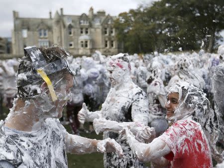 Students from St Andrews University are covered in foam as they take part in the traditional 'Raisin Weekend' in the Lower College Lawn, at St Andrews in Scotland, Britain October 17, 2016. REUTERS/Russell Cheyne