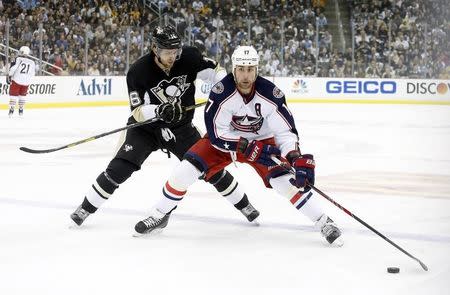 Columbus Blue Jackets center Brandon Dubinsky (17) carries the puck ahead of Pittsburgh Penguins center Brandon Sutter (16) during the first period in game five of the first round of the 2014 Stanley Cup Playoffs at the CONSOL Energy Center. April 26, 2014; Pittsburgh, PA, USA;Charles LeClaire-USA TODAY Sports