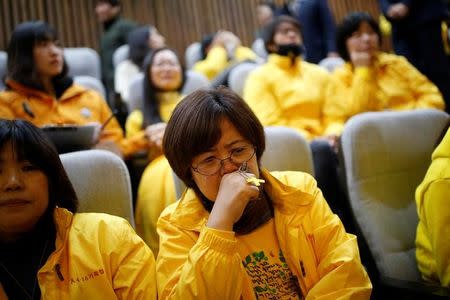 Relatives of victims who were onboard sunken ferry Sewol react as assembly Speaker Chung Sye-kyun announces the result of the impeachment vote on South Korean President Park Geun-hye during a plenary session at the National Assembly in Seoul, South Korea, December 9, 2016. REUTERS/Kim Hong-Ji