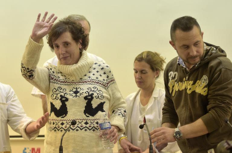 Former ebola patient Spanish nurse Teresa Romero (L) waves flanked by her husband Javir Limon (R) after a press conference at Carlos III Hospital in Madrid on November 5, 2014 following her recovery from the deadly virus