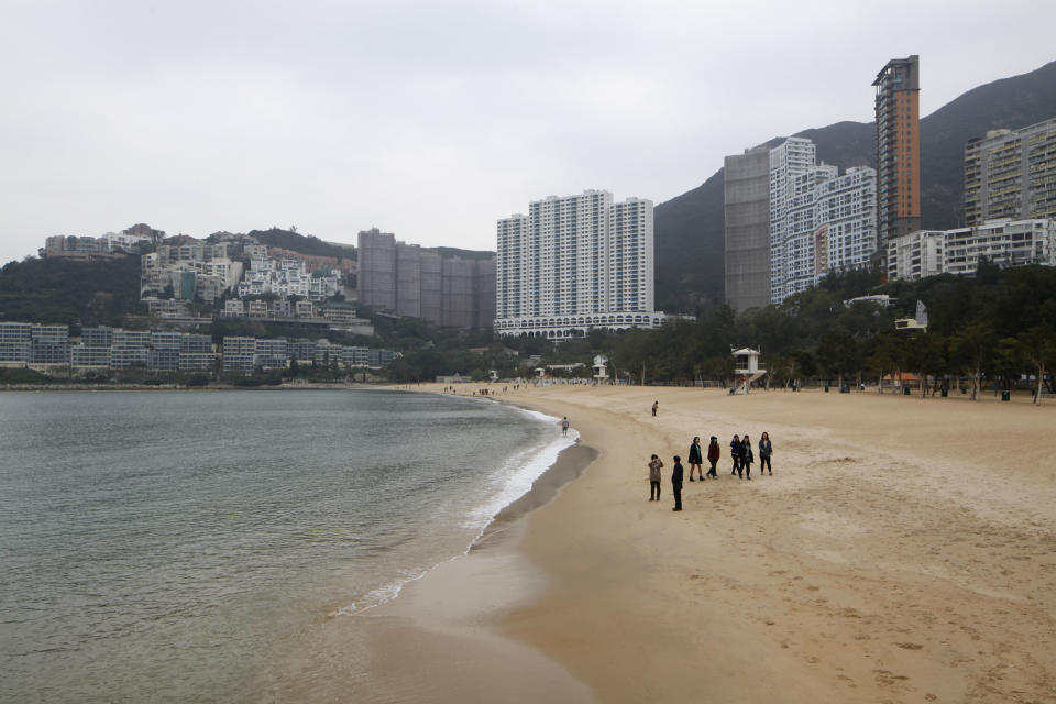 In this Jan. 15, 2013 photo, visitors walk on the Repulse Bay Beach in Hong Kong. If you visit Hong Kong at any time except the winter, you'll likely encounter sweltering weather. To cool down, head to one of the many beaches. Hong Kong Island has a few, including Big Wave Bay in Shek O or the beach at tony Repulse Bay, but they do get crowded on weekends. (AP Photo/Kin Cheung)