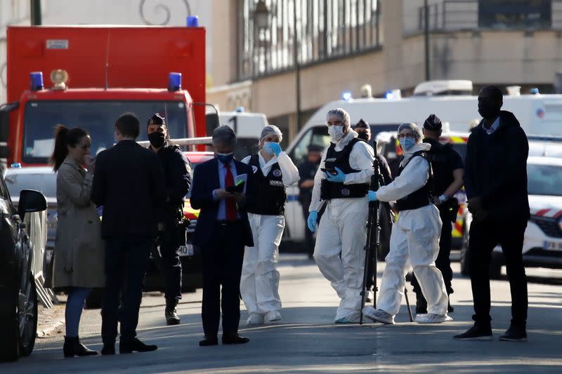 Police secure the area where an attacker stabbed a woman, in Rambouillet