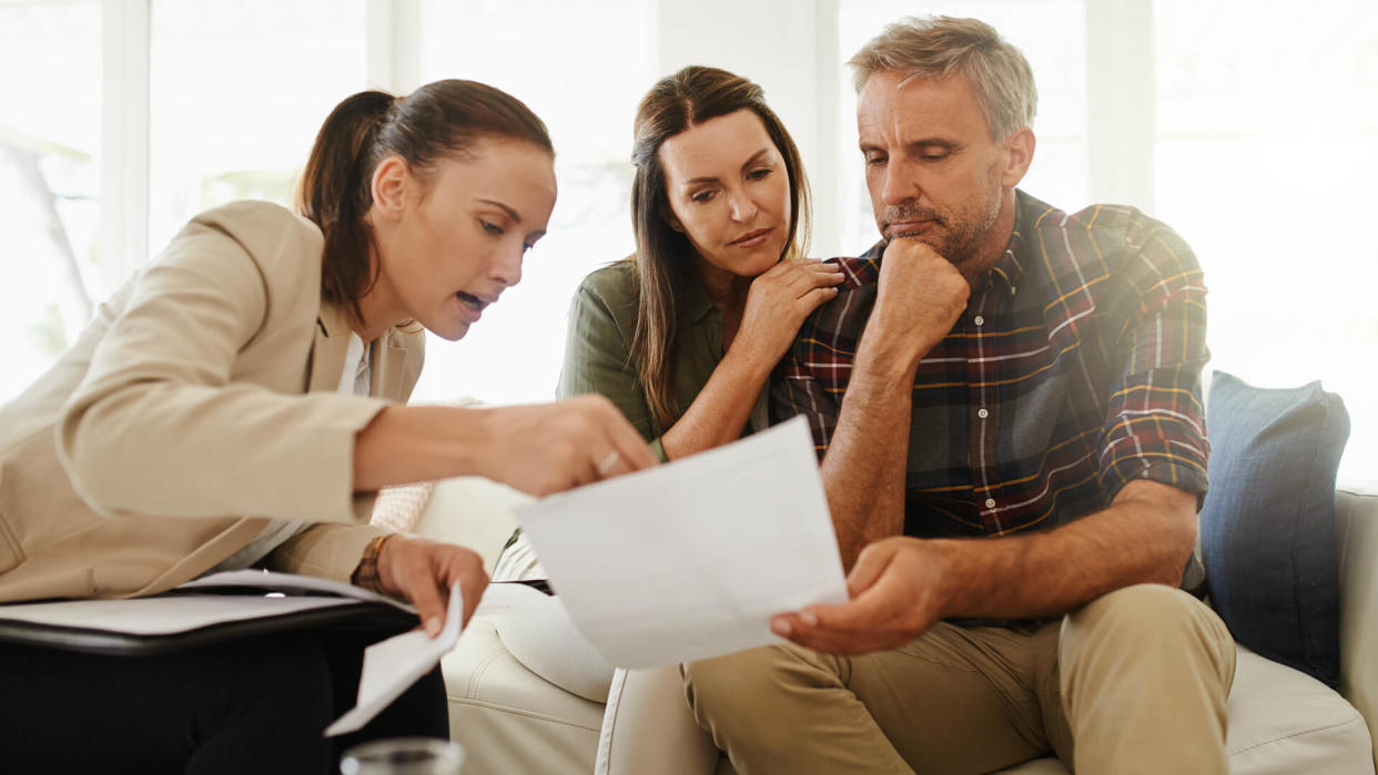 Shot of a mature couple getting advice from their financial consultant at home.