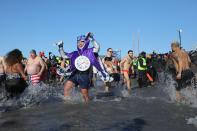 <p>Participants rush in the water during a polar bear plunge at the beach in Coney Island, Brooklyn on Jan. 1, 2018. New Yorkers took part in new year’s day swim with temperature standing at -7 degrees Celsius. (Photo: Atilgan Ozdil/Anadolu Agency/Getty Images) </p>