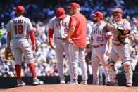 Los Angeles Angels starting pitcher Jaime Barria, second from left, is pulled from the mound during the fourth inning of a baseball game against the Seattle Mariners, Saturday, Aug. 6, 2022, in Seattle. (AP Photo/Caean Couto)