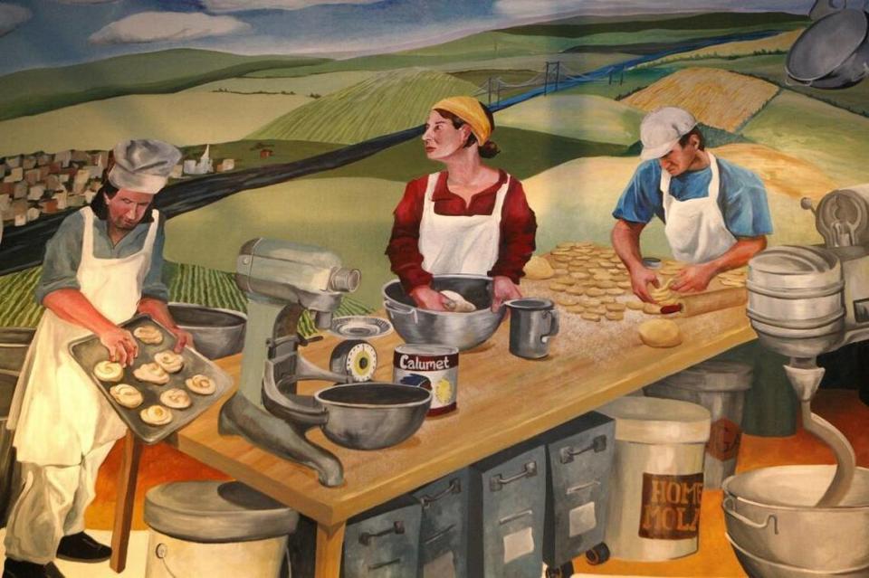 Mural depicting Greg Higgins making danish, right, with his late mother Joyce Higgins at Magee’s Bakery. The mural features Maysville and the Ohio River in the background in homage to the bakery’s founding in the 1930s in Maysville by Leslie Magee.