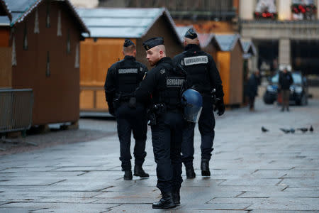 French Gendarmes patrol past wooden barracks shops at the traditional Christkindelsmaerik (Christ Child market) closed the day after a shooting in Strasbourg, France, December 12, 2018. REUTERS/Vincent Kessler