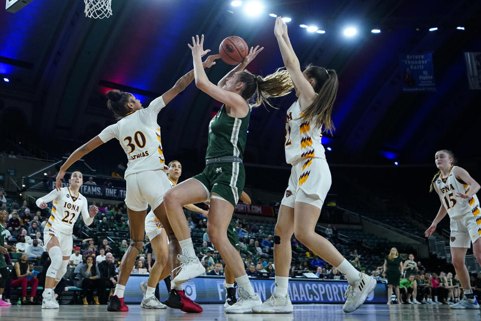 Iona center Ketsia Athias (30) blocks a shot by Manhattan forward Petra Juric, center, during the first half of an NCAA college basketball game in the championship of the Metro Atlantic Athletic Conference Tournament, Saturday, March 11, 2023, in Atlantic City N.J. (AP Photo/Matt Rourke)