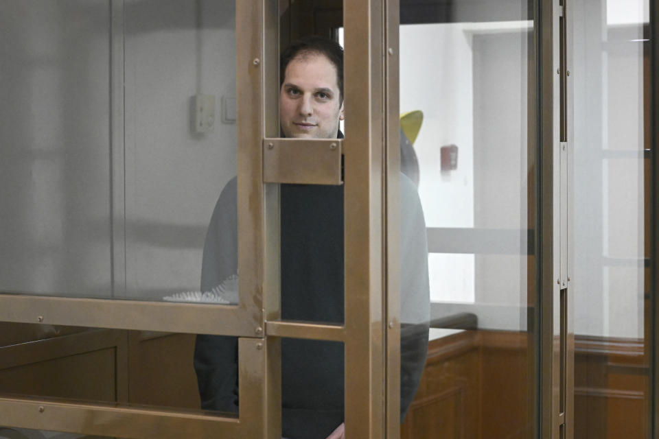 Wall Street Journal reporter Evan Gershkovich stands in a glass cage in a courtroom at the Moscow City Court, in Moscow, Russia, on Thursday, Dec. 14, 2023. Wall Street Journal reporter Evan Gerhskovich, arrested in Russia on espionage charges, will remain in detention until Jan. 30, a court in Moscow ruled on Thursday. The hearing took place behind closed doors because authorities say details of the criminal case against the American journalist are classified. (AP Photo/Dmitry Serebryakov)