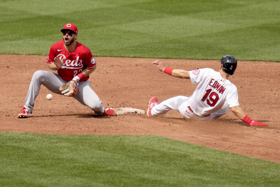 St. Louis Cardinals' Tommy Edman (19) is safe at second for a stolen base as Cincinnati Reds shortstop Mike Freeman handles the throw during the sixth inning of a baseball game Sunday, June 6, 2021, in St. Louis. (AP Photo/Jeff Roberson)