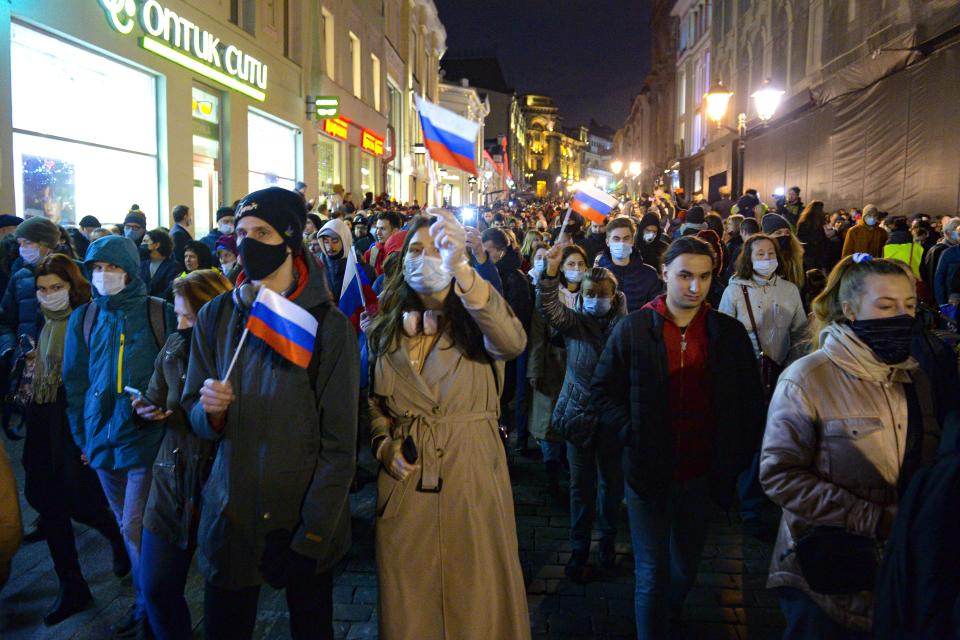 People with Russian national flags attend the opposition rally in support of jailed opposition leader Alexei Navalny in Moscow, Russia, Wednesday, April 21, 2021. Police across Russia have detained large numbers of people in connection with demonstrations in support of imprisoned opposition leader Alexei Navalny, according to a human rights group. (AP Photo/Denis Kaminev)