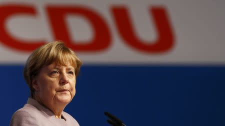 German Chancellor and leader of the conservative Christian Democratic Union party CDU Angela Merkel walks inside the Grugahalle in Essen ahead a CDU party convention in Essen, Germany, December 5, 2016. REUTERS/Wolfgang Rattay