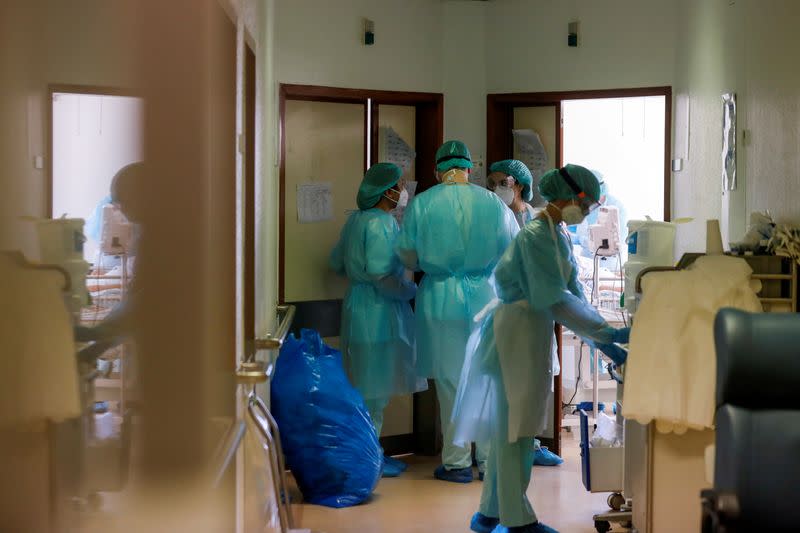 FILE PHOTO: Healthcare workers wear personal protective equipment in Santa Maria Hospital Intermediate care unit in Lisbon, Portugal