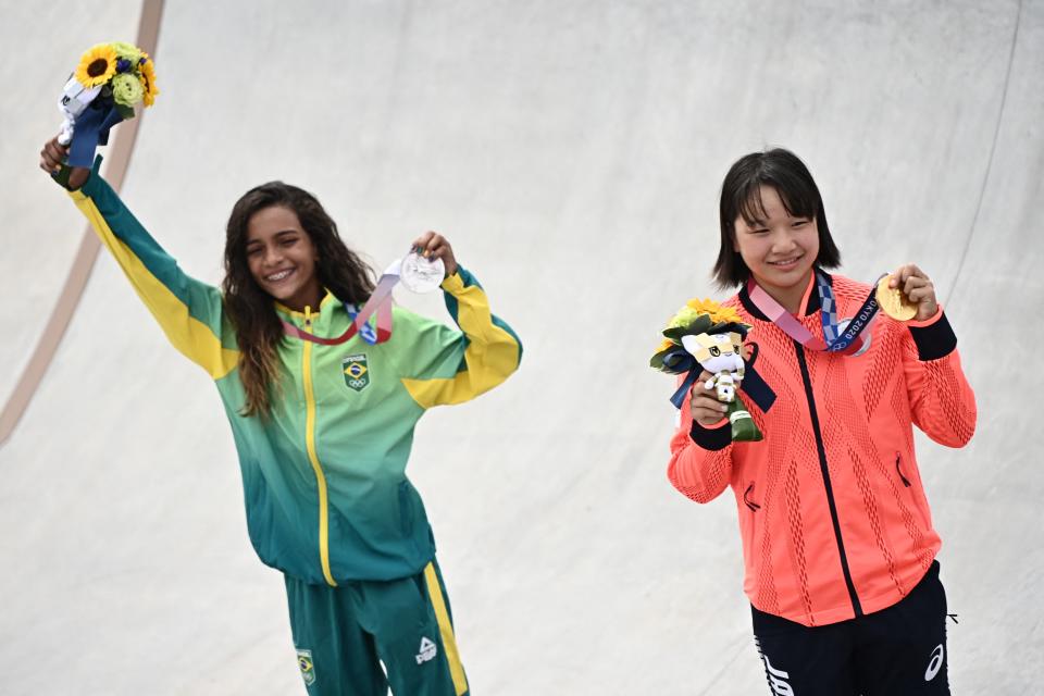 Japan's Momiji Nishiya (right) and Brazil's Rayssa Leal won gold and silver, respectively, in the women's street final of Olympic skateboarding on Monday. And they're a combined 26 years old. (Photo by LIONEL BONAVENTURE/AFP via Getty Images)