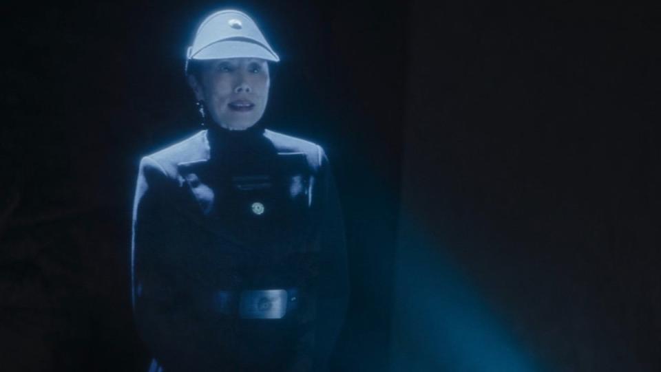 A female Imperial officer in hologram form during the Shadow Council on The Mandalorian