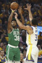 Boston Celtics guard Marcus Smart (36) shoots against Golden State Warriors guard Stephen Curry (30) during the first half of Game 1 of basketball's NBA Finals in San Francisco, Thursday, June 2, 2022. (AP Photo/Jed Jacobsohn)