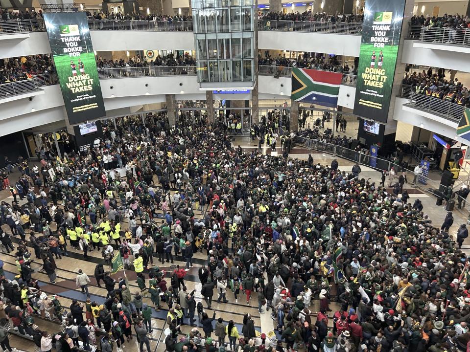 Fans greet South Africa' Springbok squad as they arrive at O.R Tambo international airport in Johannesburg, South Africa, Tuesday Oct. 31, 2023, after the Rugby World Cup. (AP Photo/Jerome Delay)