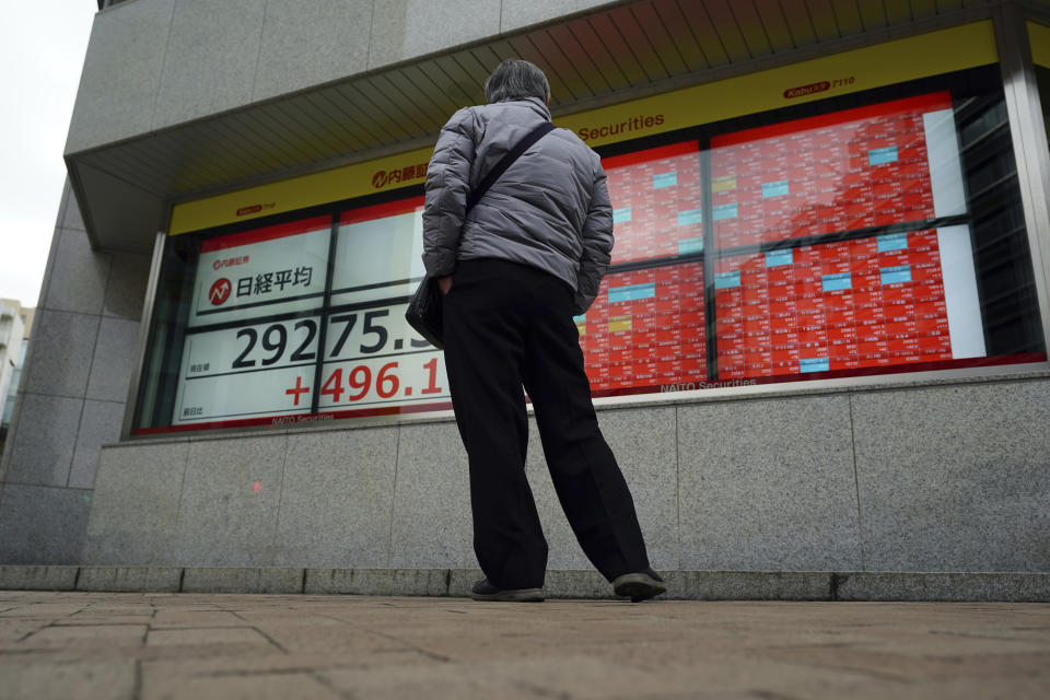 A man looks at an electronic stock board showing Japan's Nikkei 225 index at a securities firm Monday, Feb. 8, 2021, in Tokyo. Asian shares mostly rose Monday, tracking a rally on Wall Street last week, with Japan's benchmark momentarily reaching three-decade highs, on growing optimism about the global economy.(AP Photo/Eugene Hoshiko)