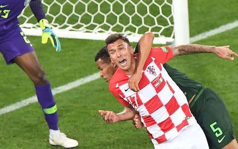 Nigeria's defender William Troost-Ekong (R) makes a fault on Croatia's forward Mario Mandzukic - Is VAR getting it right in Russia? - Credit: Attila Kisbenedek/AFP